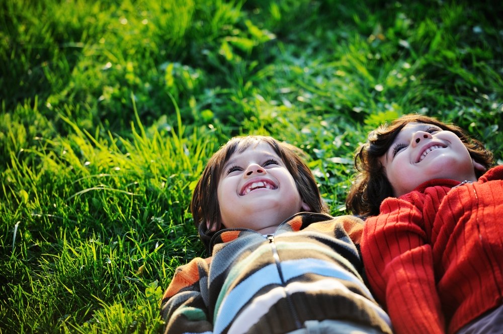 Children enjoying the grassy area where their transportable home could go