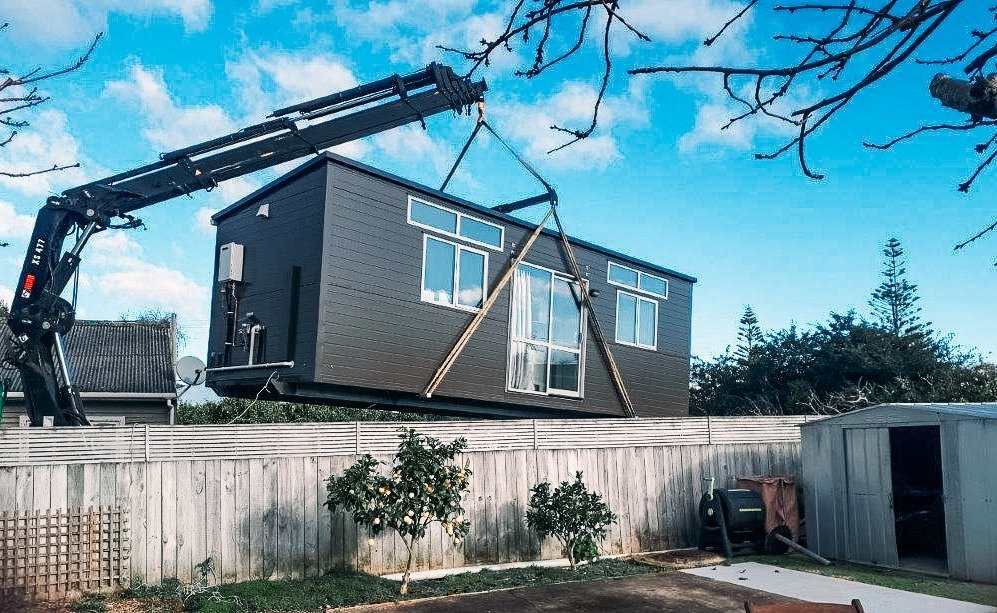 Transportable unit being craned on to property in New Zealand